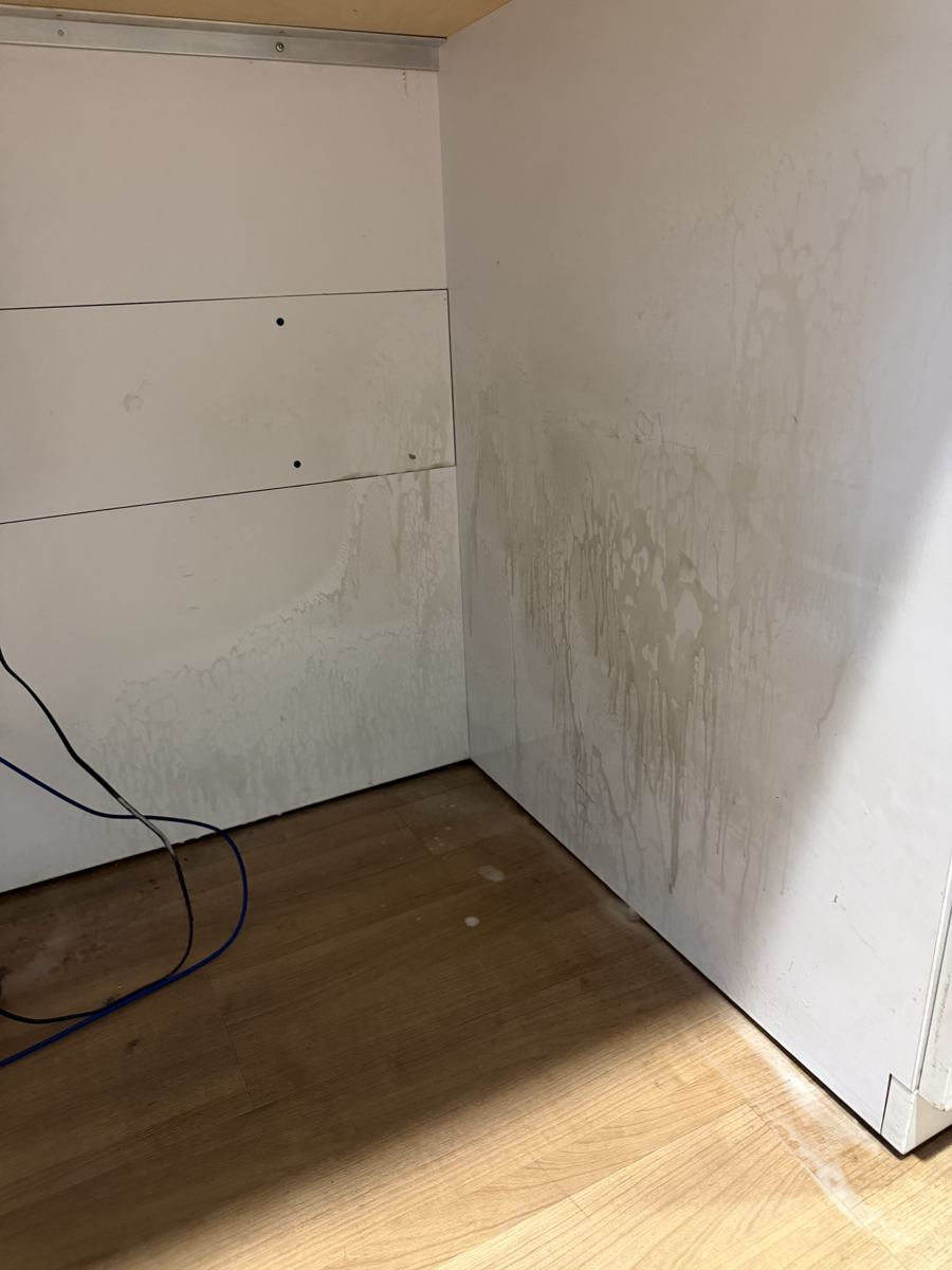 Stained cabinet interior before cleaning
