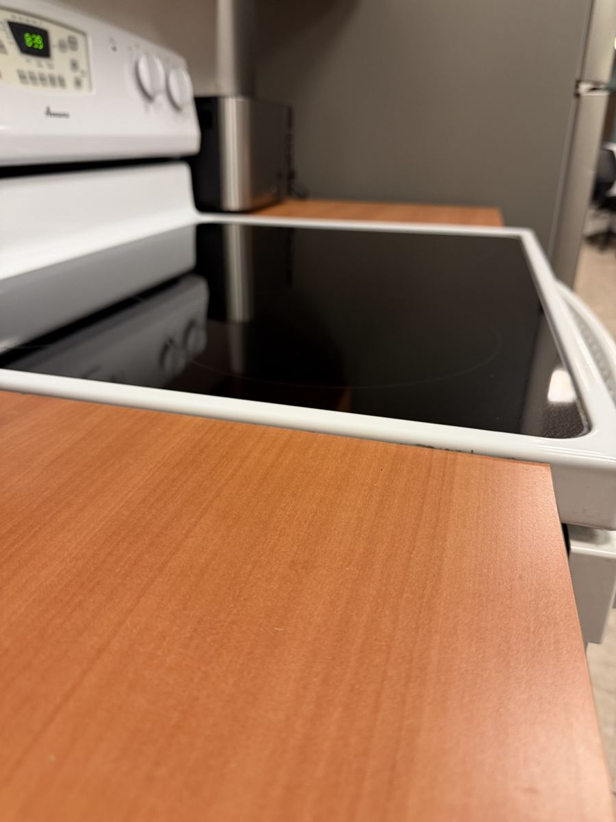 Break-room stovetop wiped to a shine